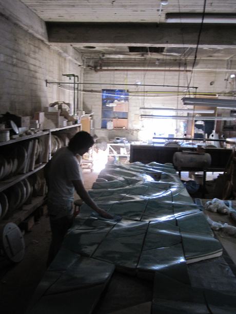 Dakota Warren working on ceramic mural tiles